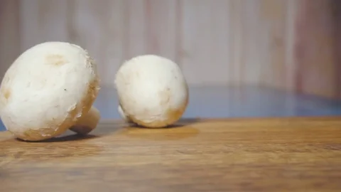 Chef cuts the champignon in half Stock Footage 73816324