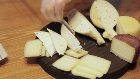 A chef cuts cheese on a cutting board. Close up Stock Footage 130655980