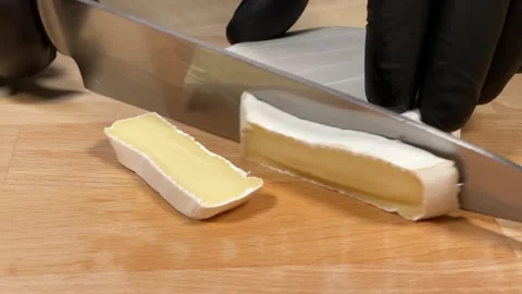 The chef cuts cheese for the dish 스톡 동영상 306803767