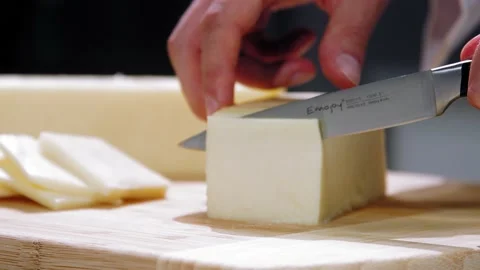 Chef cuts cheese Stock Footage 219809914