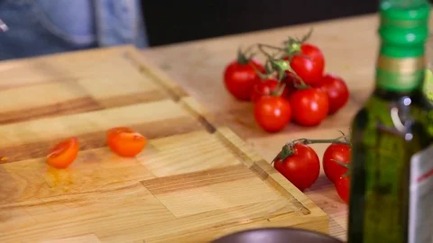 Chef cuts cherry tomatoes close-up Stock Footage 74428430