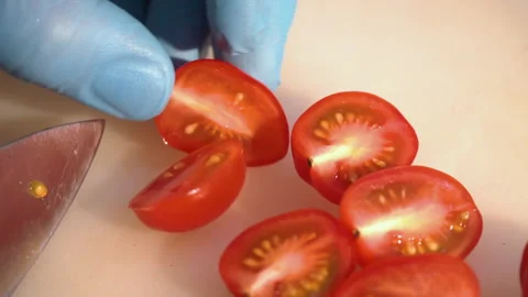 Chef cuts cherry tomatoes for salad Stock Footage 158020351