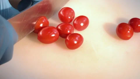 Chef cuts cherry tomatoes for salad Stock Footage 158020353