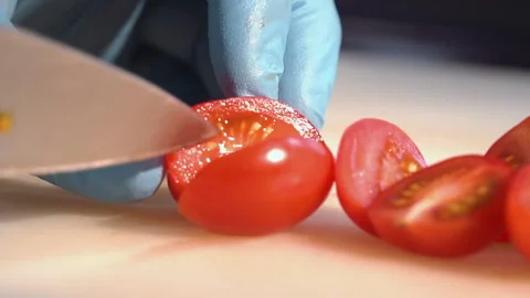 Chef cuts cherry tomatoes for salad Stock Footage 158020364