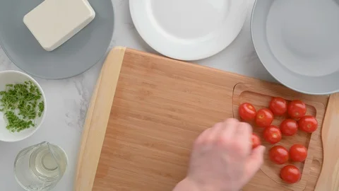 Chef cuts cherry tomatoes. Vegan food. Summer refreshing salad. Stock Footage 129775278