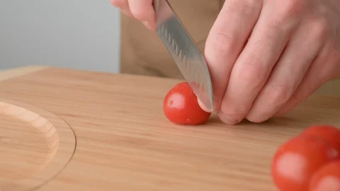 Chef cuts cherry tomatoes. Vegan food. Cooking summer refreshing salad. Stock Footage 129817749