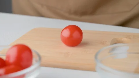 Chef cuts cherry tomatoes. Vegan food. Cooking summer refreshing salad. Stock Footage 129945341