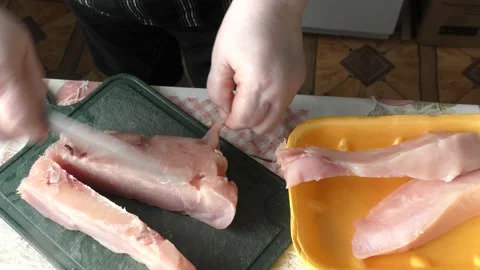 The chef cuts the chicken breast with a knife Stock Footage 169330358