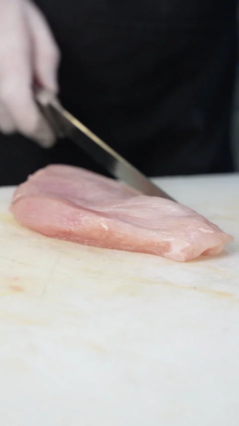 Chef Cuts Chicken With Knife Video stock 296023250
