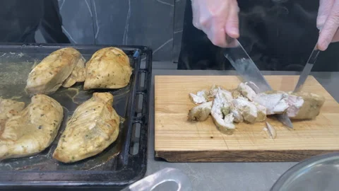 Chef cuts chicken meat with a kitchen axe. Stock Footage 244710542