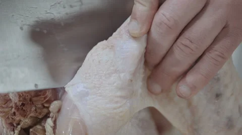 Chef cuts the chicken, turkey with a sharp knife in the kitchen Stock Footage 68721234