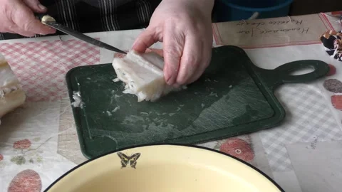 The chef cuts a cod fish with a knife Video stock 168050380