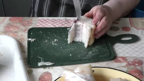 The chef cuts a cod fish with a knife Video stock 168050408