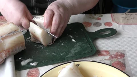 The chef cuts a cod fish with a knife Stock Footage 168050409