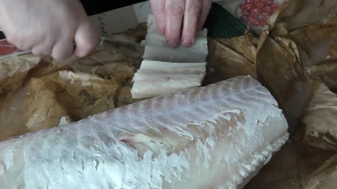 The chef cuts the cod fish into pieces Stock Footage 194141226