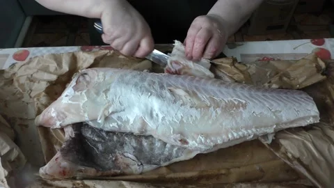 The chef cuts the cod fish into pieces Stock Footage 194141296
