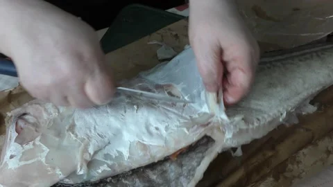 The chef cuts the cod fish into pieces Stock Footage 194145502