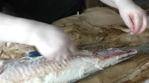 The chef cuts the cod fish into pieces Stock Footage 194158376