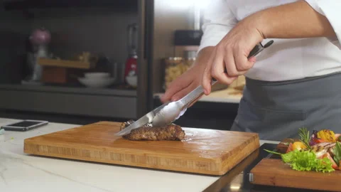 Chef Cuts Cooked Grilled Steak With Knife, Serves Platter With Meat At Kitchen. 스톡 동영상 142819773