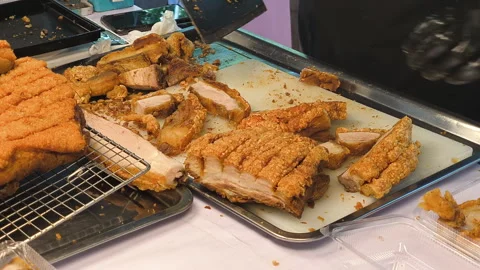 Chef cuts crispy pork into pieces to sell at street food in Thailand. Stock Footage 307512984