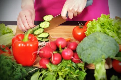 Chef cuts cucumber Stock Photos