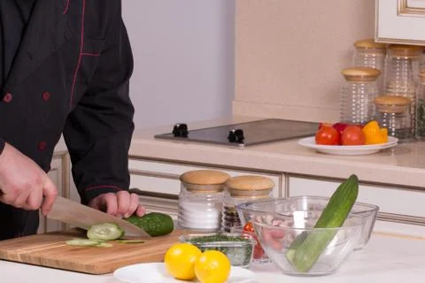 The chef cuts the cucumber Stock Photos
