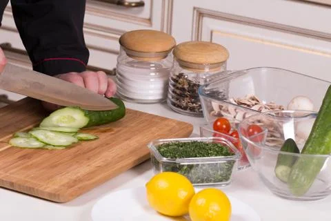The chef cuts the cucumber Stock Photos