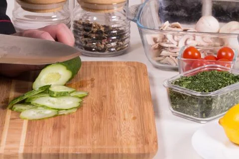 The chef cuts the cucumber Stock Photos