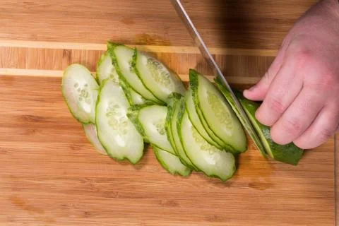 The chef cuts the cucumber Stock Photos