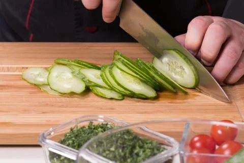 The chef cuts the cucumber Stock Photos