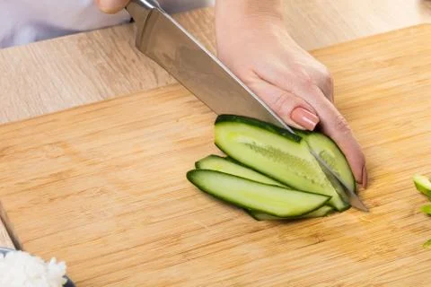 Chef cuts cucumber Stock Photos