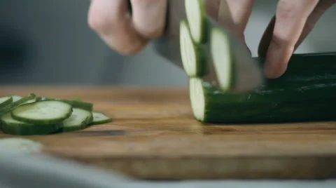 Chef cuts the cucumber with a sharp knife in the kitchen Stock Footage 68722013