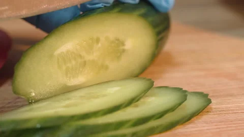 The chef cuts cucumbers into slices Stock Footage 158021666