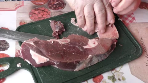 Chef cuts deer meat with a knife, healthy food concept Stock Footage 154443267
