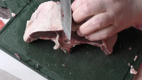 Chef cuts deer meat with a knife, healthy food concept Stock Footage 154444114