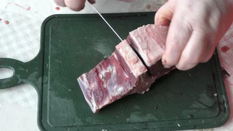 The chef cuts deer meat with a knife Stock Footage 164347926