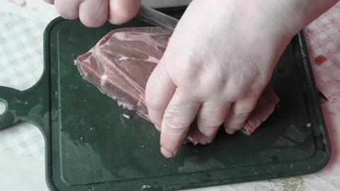 The chef cuts deer meat with a knife Stock Footage 164350803