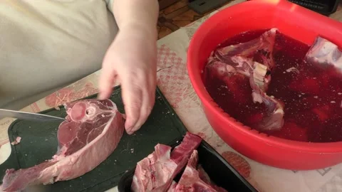 The chef cuts deer meat with a knife Stock Footage 166334987