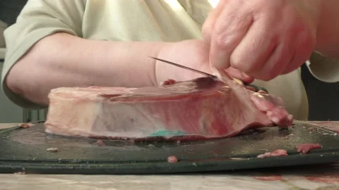 The chef cuts deer meat with a knife Stock Footage 166335048