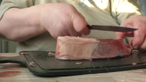 The chef cuts deer meat with a knife Stock Footage 166335211