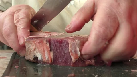 The chef cuts deer meat with a knife Stock Footage 166335216