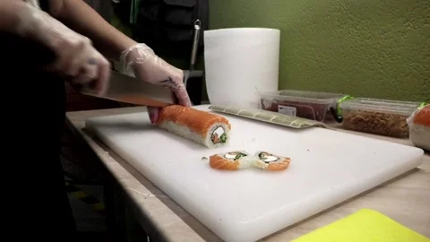 The chef cuts delicious sushi with a sharp knife Stock Footage 285436690