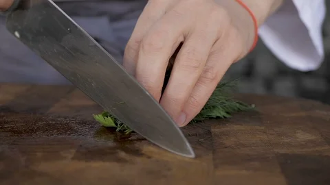 Chef cuts dill with a knife, close-up Stock Footage 107901184
