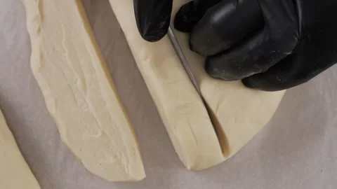 Chef cuts the dough on the table. Stock Footage 307729162