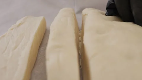 Chef cuts the dough on the table. Stock Footage 307729164