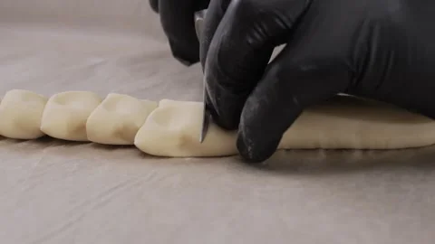 Chef cuts the dough on the table. Stock Footage 307729206