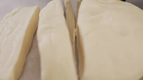 Chef cuts the dough on the table. Stock Footage 308521079