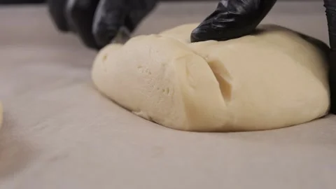 Chef cuts the dough on the table. Stock Footage 309622101