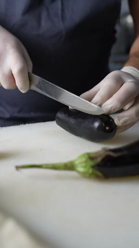 Chef Cuts Eggplant With Knife Stock Footage 296023433