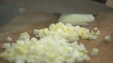 Chef cuts eggs on board to little cubes in industrial kitchen Stock Footage 71527053
